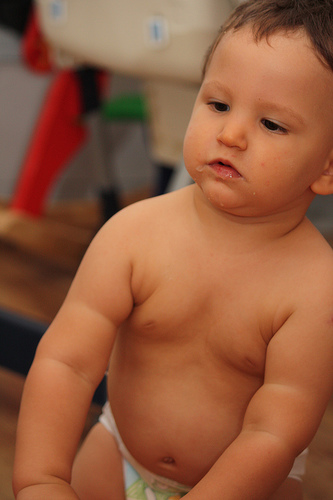 A chubby toddler naked from the waist up.