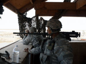 Two soldiers in a hastily built watchtower.