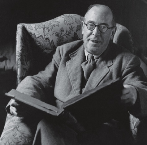 C.S. Lewis, seated with a book.